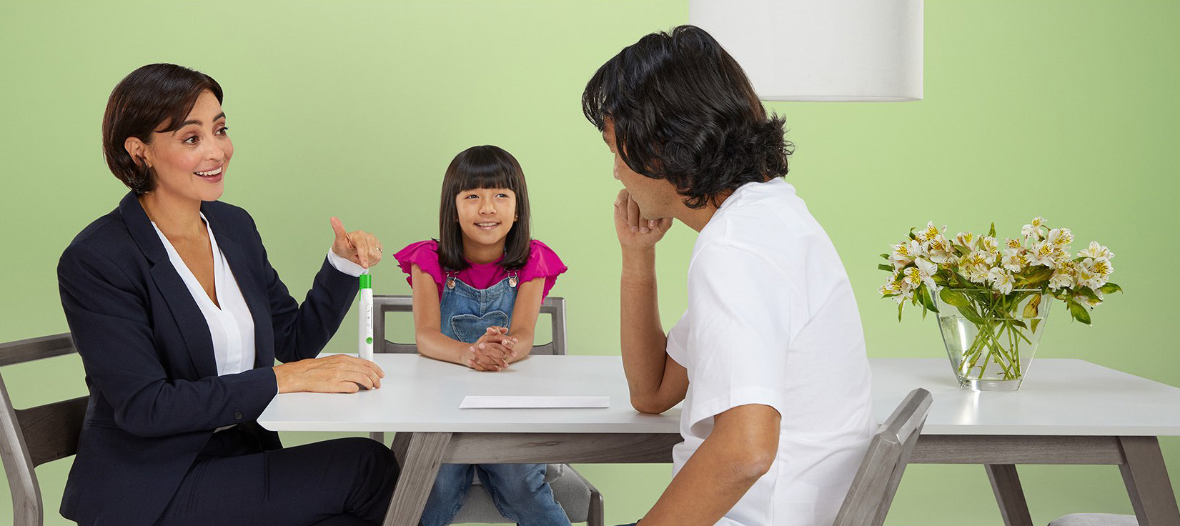 Nurse with family at table discussing Applicator